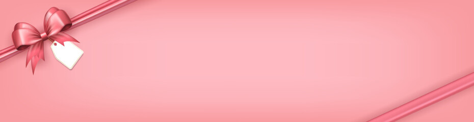Wall Mural - Panoramic banner with pink bow ribbon and paper label tag in the corner as frame and copy space for text on soft pink background. Greeting card, header with gift box with realistic 3d bow and sticker
