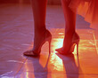 A close-up of a woman wearing high heel stilettos on a tiled floor, illuminated by red and orange lighting