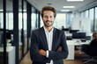 © Piotr - Confident Businessman Standing in Office With Arms Crossed