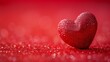 A solitary sparkling red heart on a glittery red background