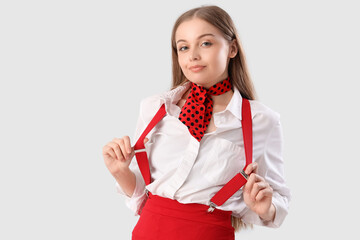 Wall Mural - Stylish young woman with suspenders on white background