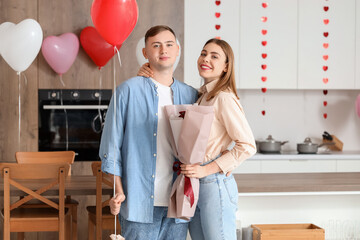 Sticker - Beautiful young couple with bouquet of flowers celebrating Valentine's Day at home