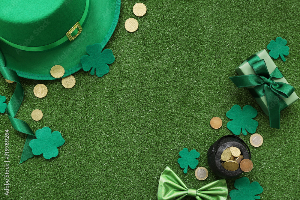 Pot with golden coins, leprechaun hat and gift box on grass. St. Patrick's Day celebration