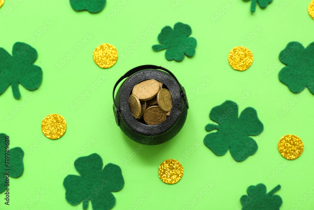 Pot with golden coins and clovers on green background. St. Patrick's Day celebration