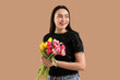 © Pixel-Shot - Happy young woman with bouquet of beautiful tulips on brown background. International Women's Day