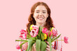 © Pixel-Shot - Happy young woman with bouquet of beautiful tulips on pink background. International Women's Day