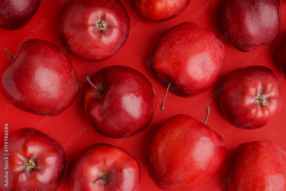 Many fresh red apples on color background