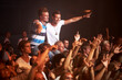 © Alexandra/peopleimages.com - Fans, dancing and music festival with hands in air and happy crowd for disco night with excitement. Young people, screaming or energy at rock event, audio or culture of listening to sound performance