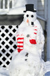 A large snowman sits alone in a front yard of a suburban Chicago home following a Midwestern United States snowstorm. The whimsical creation was made using various common household items.