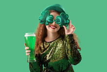 Young Woman With Beer On Green Background. St. Patrick's Day Celebration