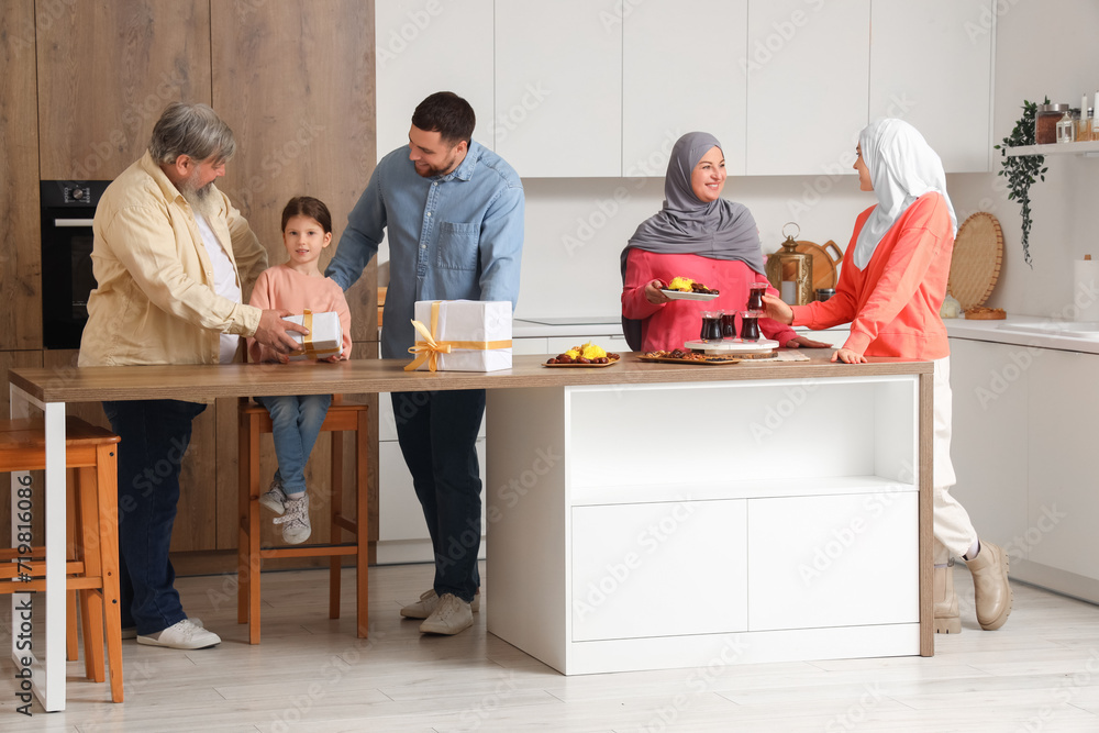 Happy Muslim family celebrating Ramadan in kitchen