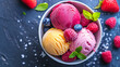 Ice cream ball with fruit flavors in a bowl black background.
