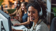 Multiethnic office team with headsets smiling as they work on computers, providing customer service and telemarketing support, selective focus 
