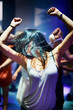 © Alexandra/peopleimages.com - Woman, dancing and music at rave, happy and party in nightclub, festival and dj event. Disco, rock and freedom with excited girl in crowd of fans for celebration, energy and techno performance