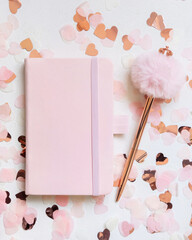 Wall Mural - Pink hardcover notebook near hearts and fur pen on white table top view, textbook mockup