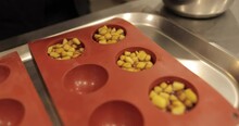 Preparation Of Apple Desserts In A Silicone Baking Tray. Filling A Silicone Tray With Diced Apples During The Work Of A Professional Confectioner.