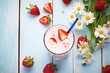 © studioworkstock - high angle of strawberry shake beside fresh strawberries