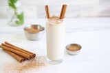 Fototapeta Sypialnia - horchata in a tall glass, topped with a sprinkle of cinnamon powder