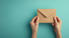 Young woman hands holding an envelope containing a love letter or a card from a friend in the mail