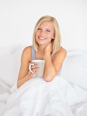 Poster - Woman, portrait and coffee in bedroom for morning relax or home beverage for comfort, peace or happy. Female person, face and smile or drinking mug on duvet or warm caffeine for vacation, rest or tea