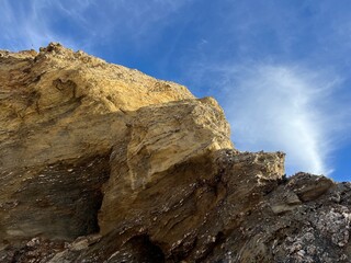 sandstone rock in the blue sky background, ocean rocky coast