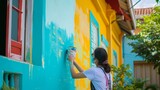 Fototapeta  - Artist Painting Vibrant Mural on Building Wall