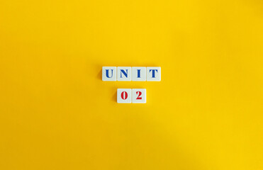 Wall Mural - unit 2. text on block letter tiles and icon on flat background. minimalist aesthetics.