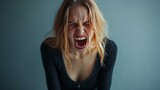 Fototapeta  - The young emotional angry woman screaming