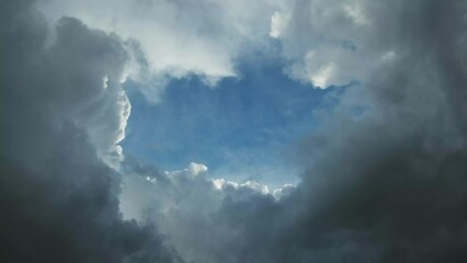Wall Mural - Dark storm clouds moving and the hole with a piece of blue sky, timelapse 4k