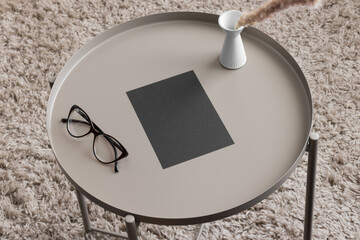 Sticker - Black invitation card mockup with a candle and a glasses on the beige table. 5x7 ratio, similar to A6, A5.