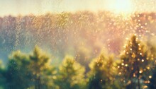 Blurred Background With Rain Drops On Glass Window Surface Misty Rainy Forest Landscape, Sunset Bokeh Light.