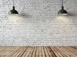 White Brick Wall With Three Lamps Illuminating the Space