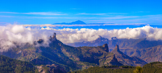 Wall Mural - Grand Canary island, panoramic view of Roque nublo over clouds and view of Theide volcano in Tenerife. Canaries islands of Spain