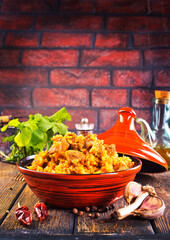 Canvas Print - Tagine with traditional uzbek pilaf on a table