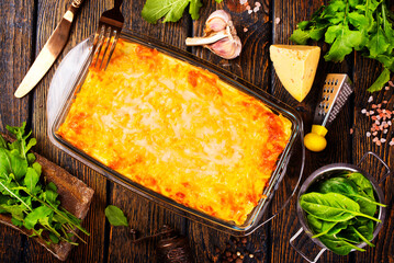 Poster - Rectangular glass bowl filled with mashed potato, underneath which is fish in cheese sauce.