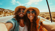 © Faith Stock - Happy young couple taking selfie on the road on a sunny day. Travel and adventure concept.