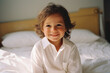 © 1005mm photography - 4 year old child smiling while sitting on bed in pajamas in his bedroom