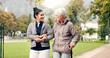 © N F/peopleimages.com - Senior woman, walker and nurse talking in a park with healthcare for elderly exercise. Walking, healthcare professional and female person with peace and physical therapy in a public garden with carer