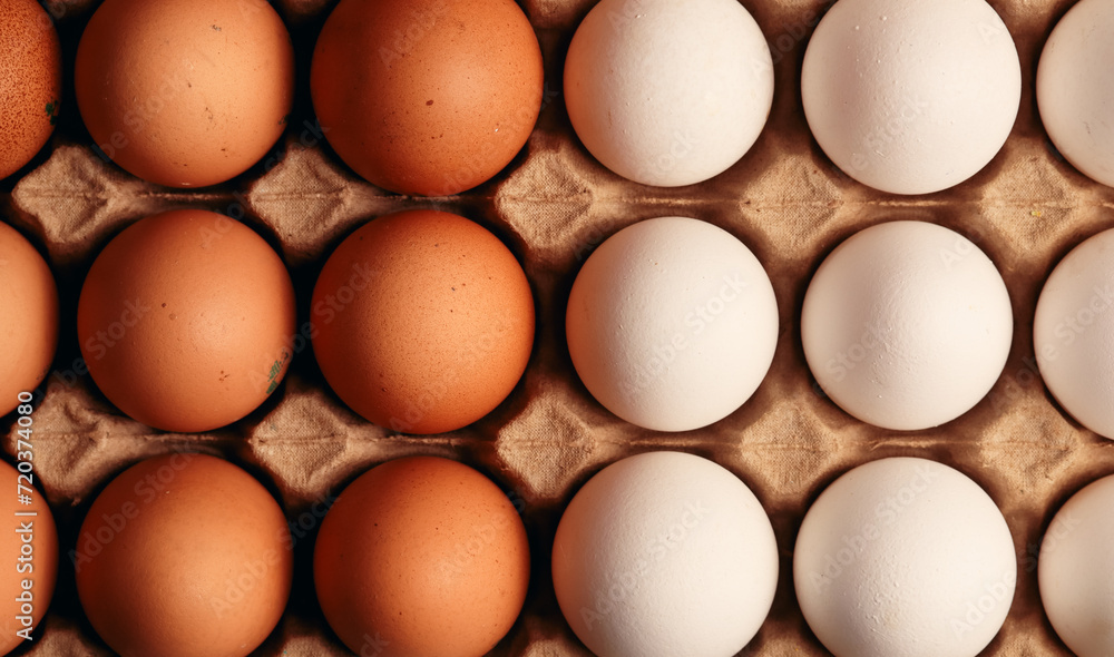 Photograph of egg carton with white eggs and brown eggs. Food concept.