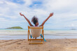 © lovelyday12 - Beachgoer enjoying a relaxing vacation on a sunny chair by the ocean, surrounded by the beauty of nature and the tranquil coastal landscape