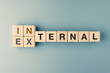 Internal versus external concept text on alphabet wood blocks