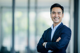 Fototapeta  - Smiling Thai businessman with office background.