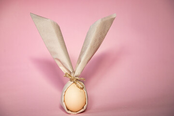 Wall Mural - egg wrapped in easter bunny shaped napkin