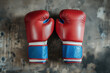 © Artem - Rocky Balboas red boxing gloves on a concrete floor. Background image. Created with Generative AI technology