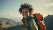 African American teenager's tourist trip or trek in autumn. Young hiker or traveler resting in camp after long hike in the mountains. Tourism and active leisure concept.