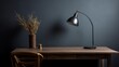Wooden desk with lamp and plant in dark room