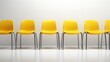 Yellow office chair standing in a row against light grey background, worker employment concept