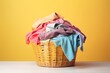 Wicker basket full of dirty clothes on wooden floor