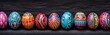 collection of brightly colored and intricately patterned Easter eggs. They are arranged in a row and have a black background. The eggs vary in size and are of different shapes.