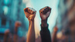 © Studio Nova - raised fists prominently centered against a blurred background.